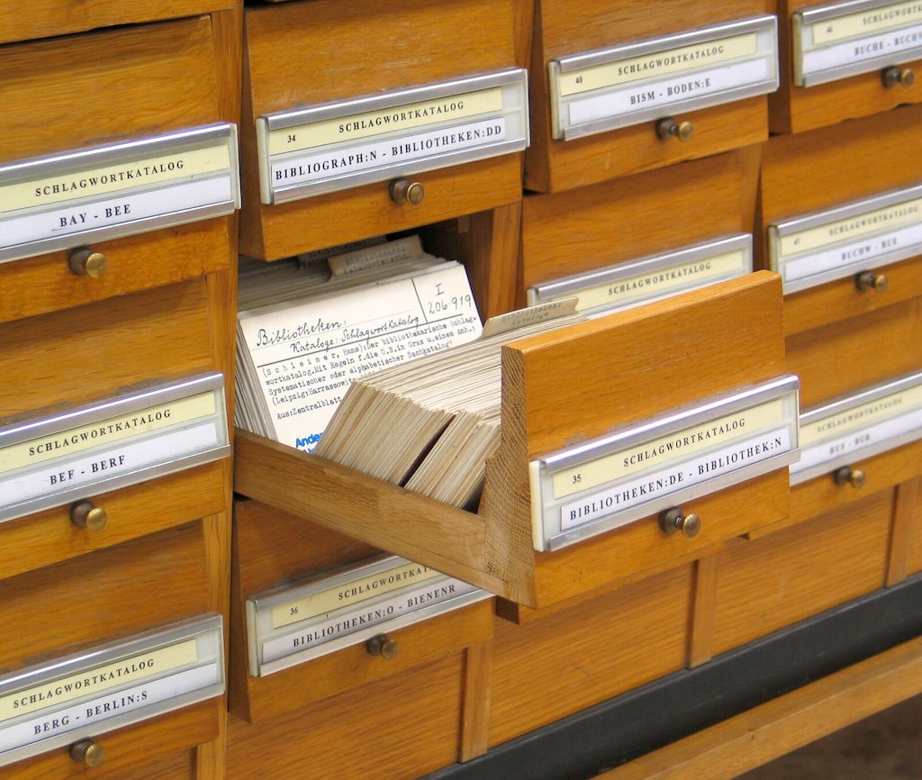 A library card catalog with one drawer open